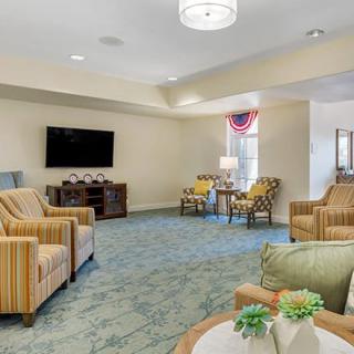 A cozy living room featuring comfortable seating, a television, and tasteful decor.