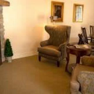 A cozy living room with a plush armchair and elegant decor.