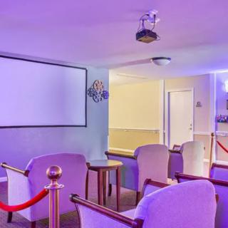 A stylish home theater room with comfortable seating and ambient lighting.