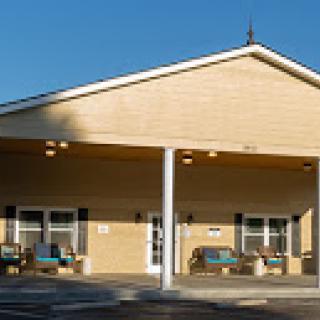 A modern building with a welcoming entrance, illuminated by the sunlight.