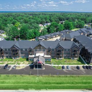Aerial view of a modern apartment complex surrounded by lush greenery.