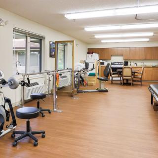 A rehabilitation center with various exercise equipment and facilities for physical therapy.