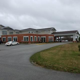 A hotel building with a welcoming entrance on a cloudy day.