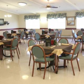 An empty dining room with arranged tables and chairs.