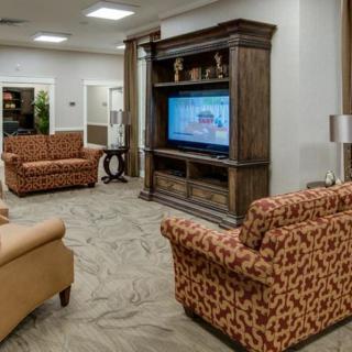 A cozy living room with stylish sofas and a large TV entertainment center.