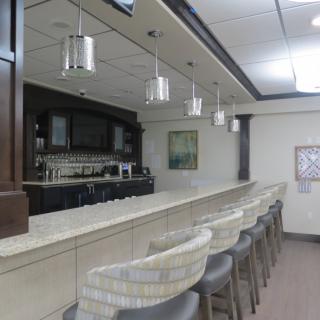 A modern bar interior with a sleek countertop and stylish seating.