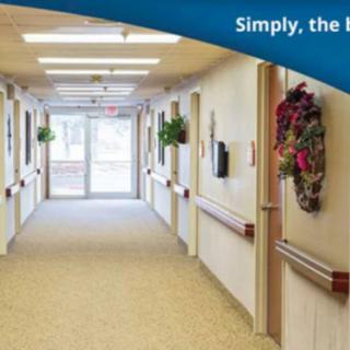 A well-lit hallway with decorative elements and a view towards an exit door.