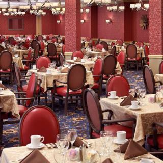 An elegant dining room with neatly arranged tables and chairs.
