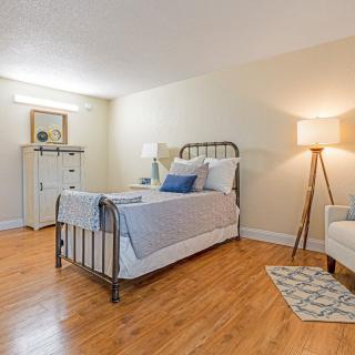 A cozy bedroom with wood flooring and a metal bed frame.