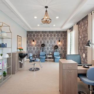 A modern salon interior with stylish decor and comfortable seating.