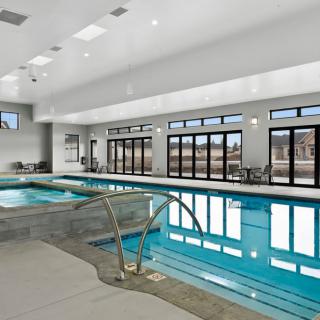 A luxurious indoor swimming pool with modern design and ample natural light.
