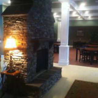 A cozy interior featuring a stone fireplace and warm lighting.