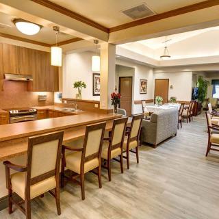 A modern kitchen and dining area with wooden furniture and bright lighting.
