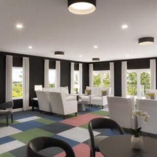 A modern living room interior with colorful flooring and minimalist furniture.