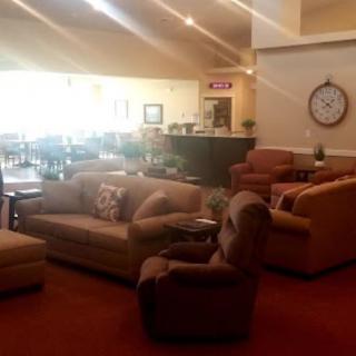 A cozy lobby with comfortable seating and warm lighting.