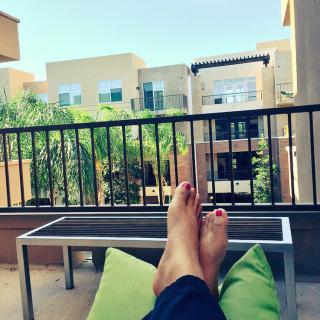 Relaxing on the balcony with a view of the cityscape.