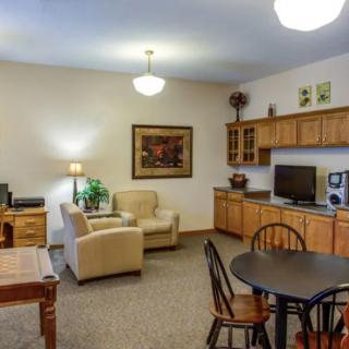 Cozy living area with a sofa, TV, and dining table in an apartment.