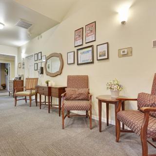 A cozy waiting area with chairs and wall decorations.