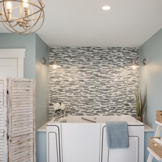 A modern bathroom with a stylish tile backsplash and freestanding bathtub.