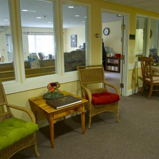 A cozy waiting area with colorful chairs and a small table.