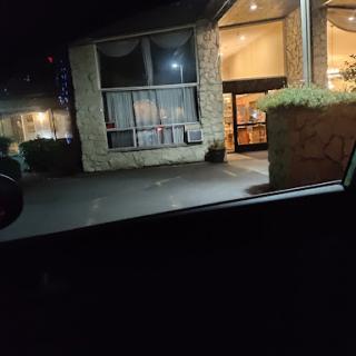 A nighttime view of a hotel entrance with soft lighting.