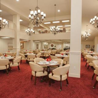 Spacious dining area with elegant chandeliers and comfortable seating.
