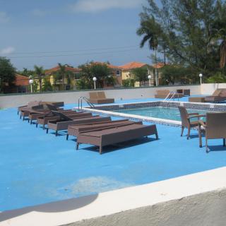 A tranquil outdoor pool area with lounge chairs perfect for relaxation.