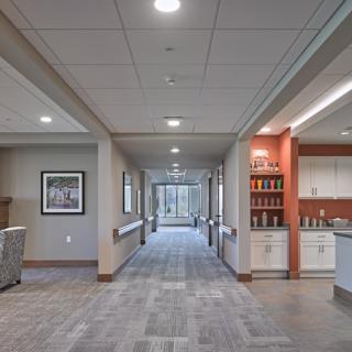 A modern office hallway with bright lighting and a clean design.