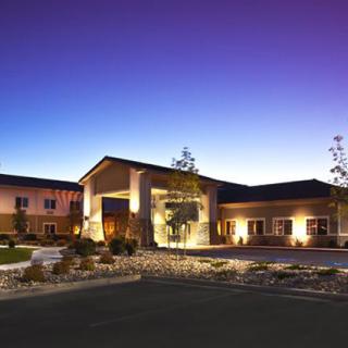 A well-lit hotel building under a twilight sky.