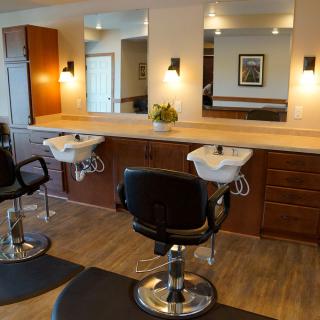 A well-appointed hair salon with chairs, mirrors, and sinks.