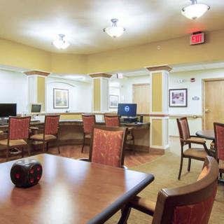 A well-lit office space featuring computers and seating areas.