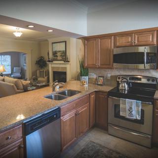 A modern kitchen with stainless steel appliances and wooden cabinetry.