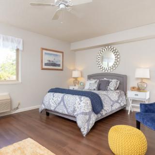 A cozy bedroom with modern decor and a spacious layout.