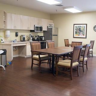 A modern kitchen and dining area with a wooden table and chairs.