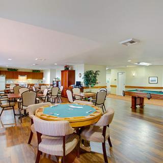 Community game room featuring a poker table and pool table.