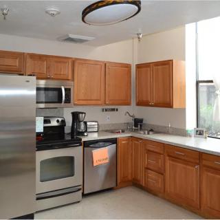 A modern kitchen with stainless steel appliances and wooden cabinets.