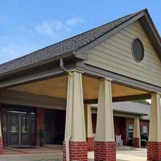 A building entrance with columns and a triangular roof section.