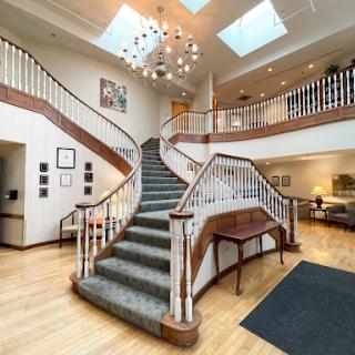 A beautifully designed lobby featuring an elegant staircase and modern lighting.