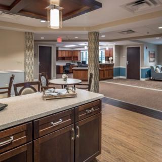 A modern open space interior featuring a kitchen and living area with stylish furnishings.