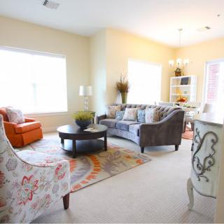 A bright and cozy living room featuring a sofa, coffee table, and stylish decor.