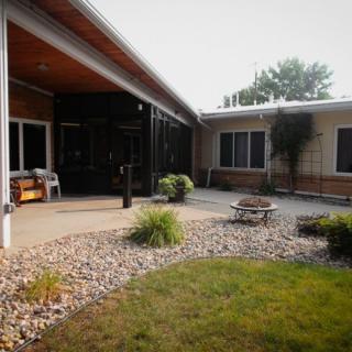 A peaceful courtyard with a patio and landscaped garden.
