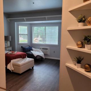 A cozy bedroom with stylish decor and natural light.