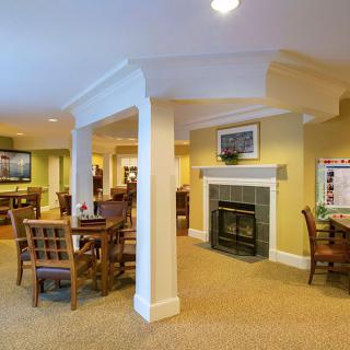 A cozy living area with a fireplace and seating arrangements.