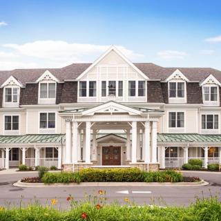 A large colonial-style building with a well-maintained exterior and clear blue sky.