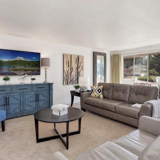 A modern and spacious living room with comfortable seating and stylish decor.