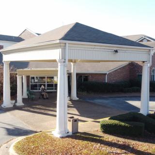 Entrance of a building with white columns and an awning.