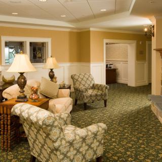 A cozy living room with patterned chairs and warm lighting.