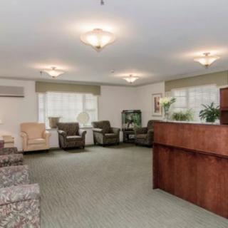 A reception area with comfortable seating and a wooden desk.