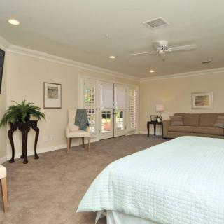 Spacious bedroom with elegant decor and natural light.