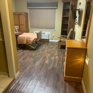 A cozy and organized room featuring a bed, dresser, and ample natural light.
